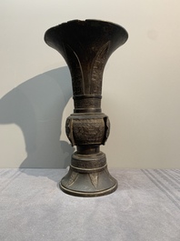 A Chinese archaistic bronze 'gu' vase with relief design, Ming