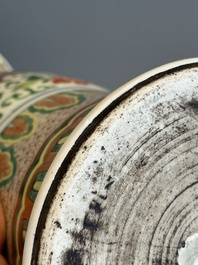 A Chinese wucai 'gu' vase with Buddhist lions, peony scrolls and figures, 19th C.