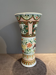 A Chinese wucai 'gu' vase with Buddhist lions, peony scrolls and figures, 19th C.