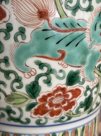 A Chinese wucai 'gu' vase with Buddhist lions, peony scrolls and figures, 19th C.
