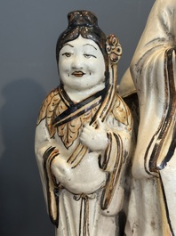 A rare Chinese Cizhou group with a dignitary, two attendants and a horse, Ming
