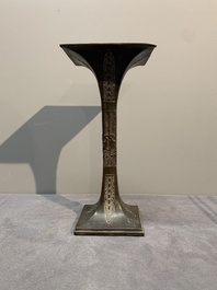 A Chinese archaistic bronze 'gu' vase and a 'hu' vase with rams in relief on a wooden stand, 18/19th C.