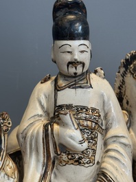 A rare Chinese Cizhou group with a dignitary, two attendants and a horse, Ming