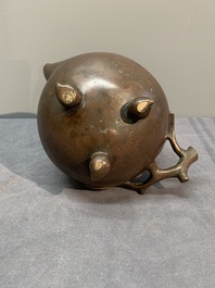 A Chinese bronze camel-form paperweight and a peach-shaped covered censer, 19th C.