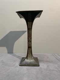 A Chinese archaistic bronze 'gu' vase and a 'hu' vase with rams in relief on a wooden stand, 18/19th C.