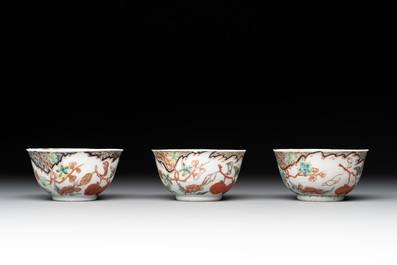 Three Chinese famille rose 'flowers and butterflies' cups and saucers, Yongzheng