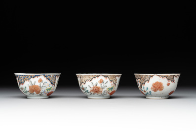 Three Chinese famille rose 'flowers and butterflies' cups and saucers, Yongzheng