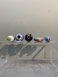 Five Chinese blue and white, iron-red and mirror-black-glazed snuff bottles, Qianlong mark, 19th C.