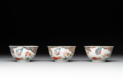 Three Chinese famille rose 'flowers and butterflies' cups and saucers, Yongzheng
