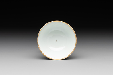 A Chinese export famille rose cup and saucer with a herring merchant, Qianlong