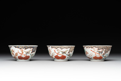 Three Chinese famille rose 'flowers and butterflies' cups and saucers, Yongzheng