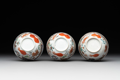 Three Chinese famille rose 'flowers and butterflies' cups and saucers, Yongzheng