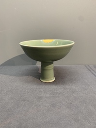 A Chinese Longquan celadon stem cup and two saucers, Ming