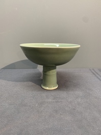 A Chinese Longquan celadon stem cup and two saucers, Ming
