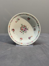 A Chinese famille rose 'Lowestoft' teapot, a plate, three cups and nine saucers, Qianlong