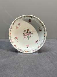 A Chinese famille rose 'Lowestoft' teapot, a plate, three cups and nine saucers, Qianlong