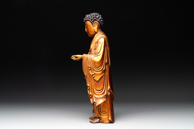 A fine Chinese gilt-lacquered wooden figure of the standing Buddha, Ming