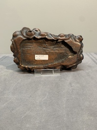 A Chinese petrified wood scholar's rock on wooden stand, 17/18th C.