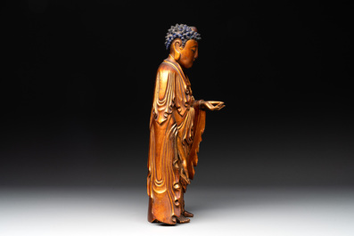 A fine Chinese gilt-lacquered wooden figure of the standing Buddha, Ming