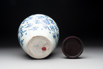 A Chinese blue and white 'lotus scroll' vase with wooden cover, Kangxi