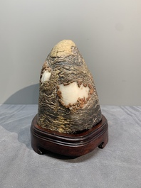 A Chinese wucai Lingbi stone scholar's rock on wooden stand, 20th C.