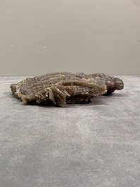 A Chinese grape agate scholar's rock on wooden stand, 20th C.