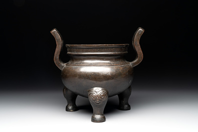 A Chinese bronze tripod censer with two handles, Ming