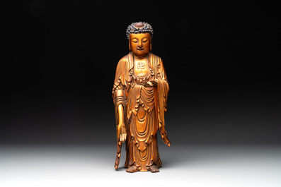 A fine Chinese gilt-lacquered wooden figure of the standing Buddha, Ming
