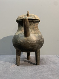 A Chinese inscribed archaic bronze tripod ritual wine vessel and cover, 'He 盉', Western Zhou