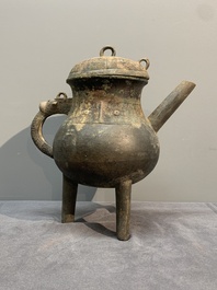 A Chinese inscribed archaic bronze tripod ritual wine vessel and cover, 'He 盉', Western Zhou