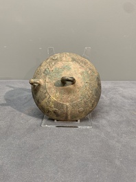 A Chinese inscribed archaic bronze tripod ritual wine vessel and cover, 'He 盉', Western Zhou