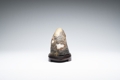 A Chinese wucai Lingbi stone scholar's rock on wooden stand, 20th C.