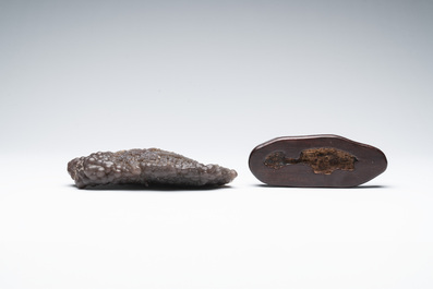 A Chinese grape agate scholar's rock on wooden stand, 20th C.