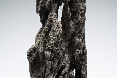 A Chinese ying stone scholar's rock on wooden stand, 20th C.