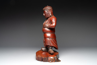 A Japanese lacquered wooden figure of a guardian, 19th C.