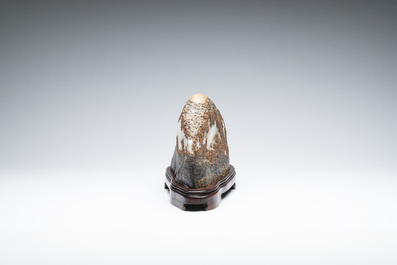 A Chinese wucai Lingbi stone scholar's rock on wooden stand, 20th C.
