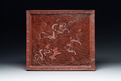 A rectangular Chinese carved red lacquer 'dragon' table screen, later wooden stand, Qianlong