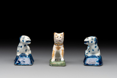 A pair of blue and white Dutch Delft miniature models of dogs and a polychrome dog, 18th C.
