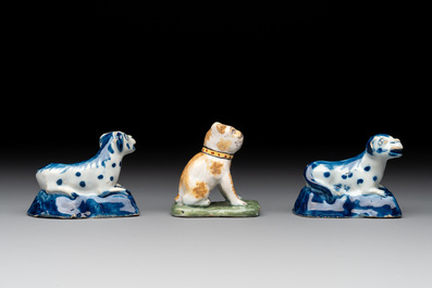 A pair of blue and white Dutch Delft miniature models of dogs and a polychrome dog, 18th C.