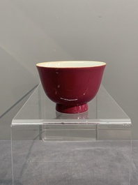 A fine Chinese ruby-ground famille rose 'magnolia' cup, Qianlong mark and of the period
