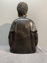 A large Chinese lacquered and gilt bronze Buddha, 17th C.
