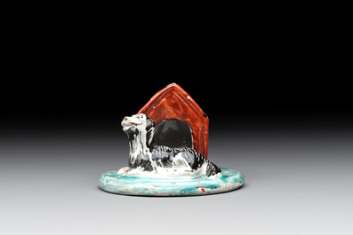 A rare polychrome Dutch Delft group of a dog in front of its doghouse, 18th C.