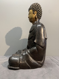 A large Chinese lacquered and gilt bronze Buddha, 17th C.