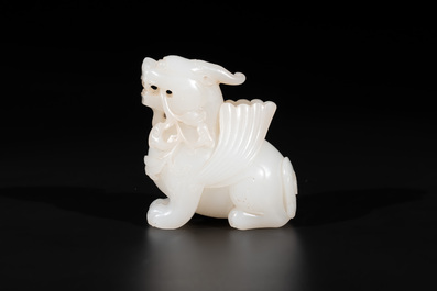 A Chinese white jade carving of a mythic animal, 19/20th C.