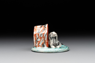 A rare polychrome Dutch Delft group of a dog in front of its doghouse, 18th C.