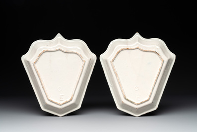 A pair of fine blue and white Dutch Delft leaf-shaped dishes with travellers in a landscape, early 18th C.