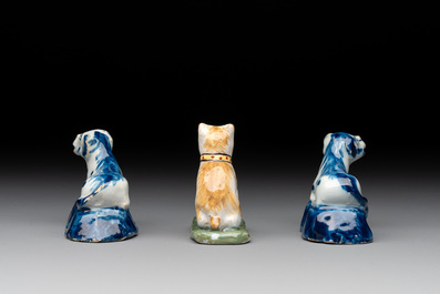 A pair of blue and white Dutch Delft miniature models of dogs and a polychrome dog, 18th C.