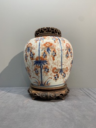 A pair of Chinese Imari-style 'grapevine' jars with wooden covers and stands, Kangxi