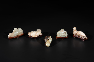 Five Chinese jade carvings with four wooden stands, 19th C.
