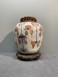 A pair of Chinese Imari-style 'grapevine' jars with wooden covers and stands, Kangxi